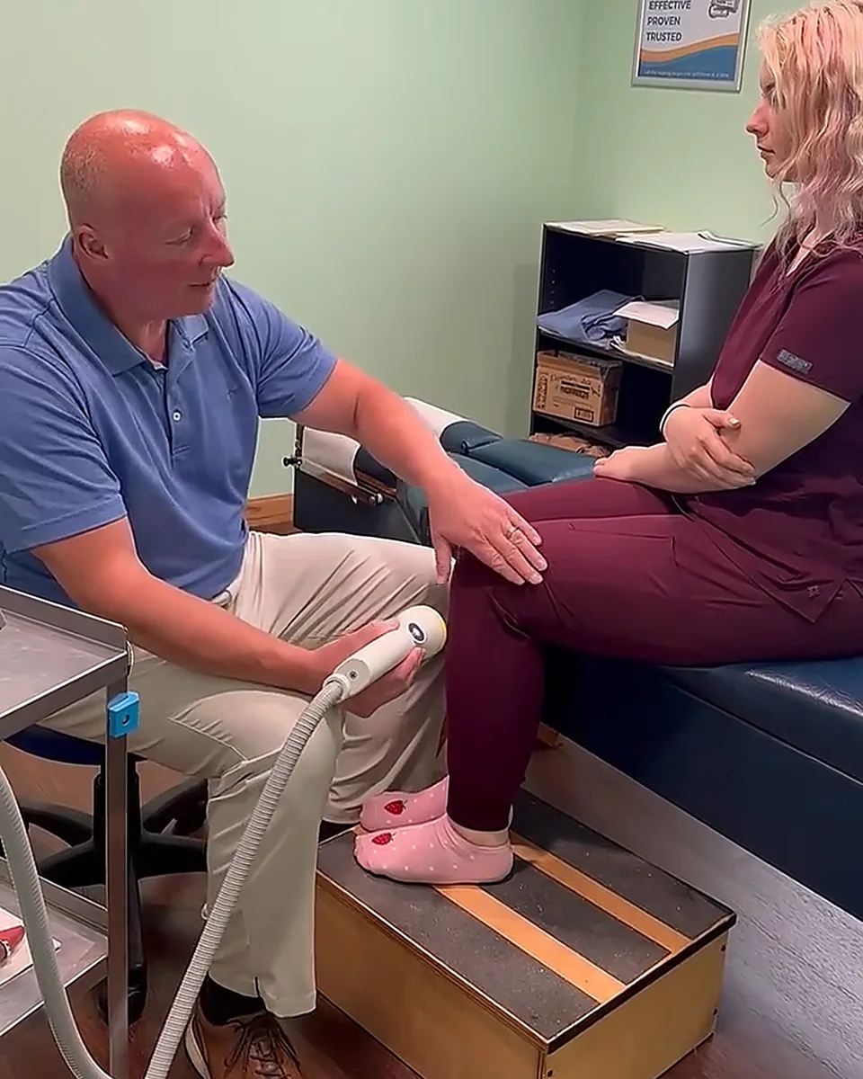 Dr. Matt Chenault treating a patient's knee with SoftWave therapy at Greenville Rehab and Pain Clinic